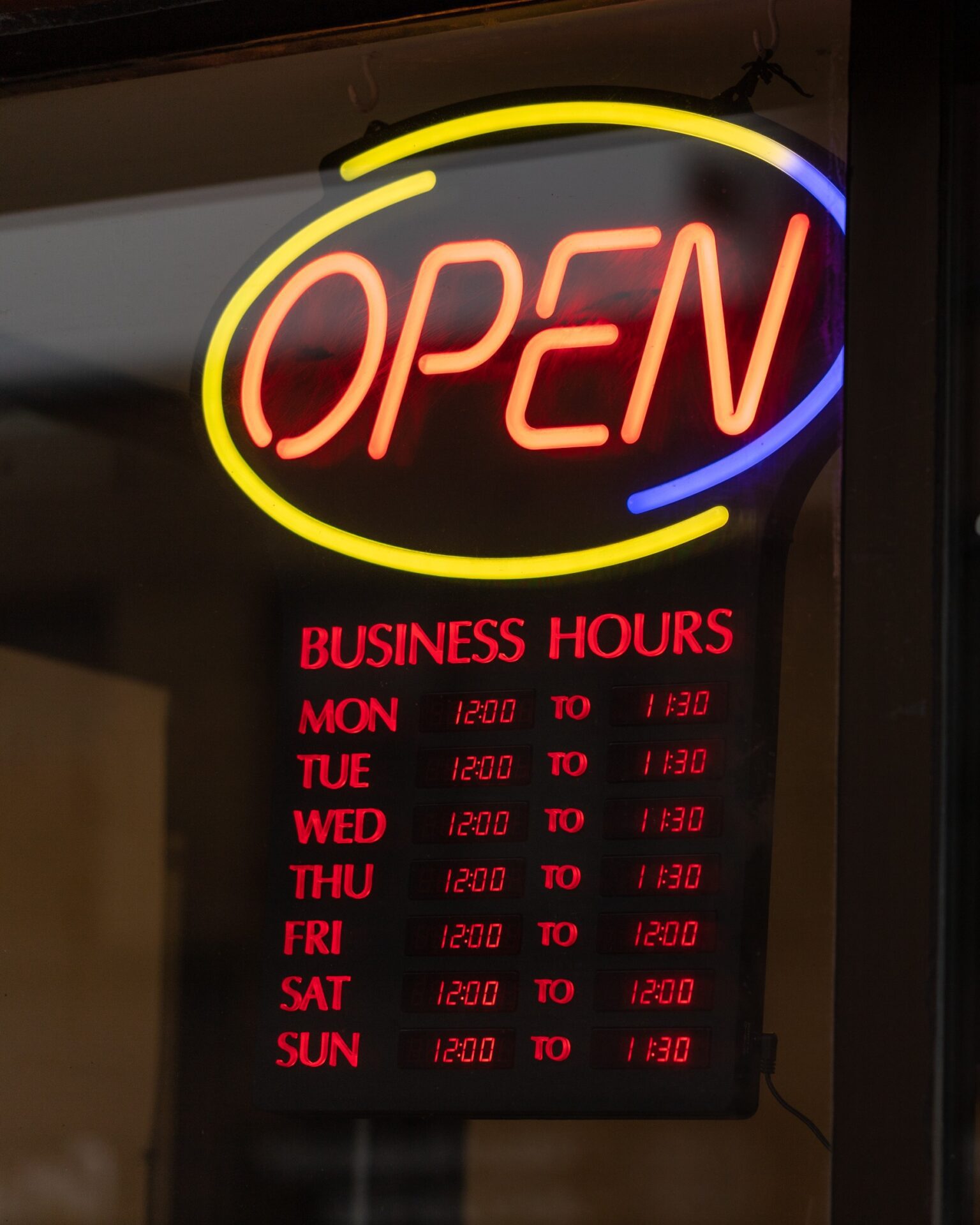 Open business hours sign on restaurant door